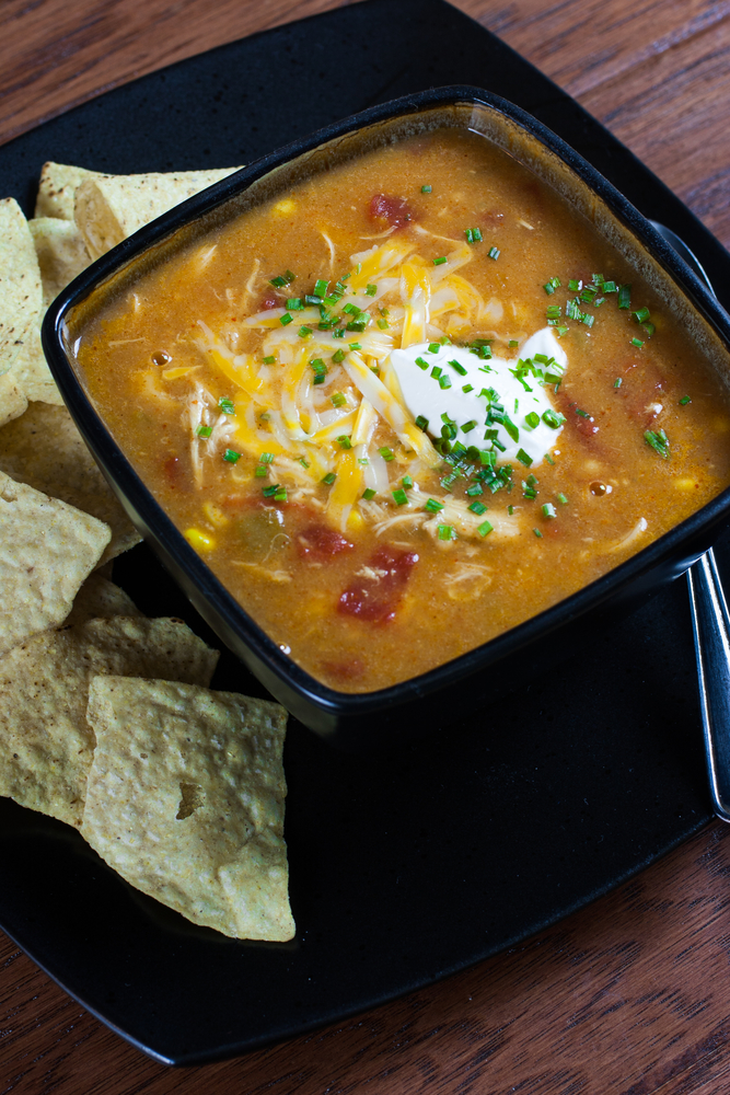 Healthy and Easy Instant Pot recipe for Chicken Enchilada Soup in a black square bowl