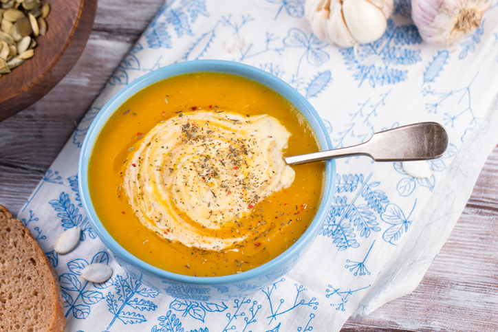 Thick and Creamy Roasted Butternut Squash Soup in a blue bowl on table