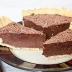 A slice of homemade chocolate pie sits on a white plate next to a fork. This healthier version of the Pioneer Woman's Easy Chocolate Pie was remade for Weight Watchers by deedeedoes.com.
