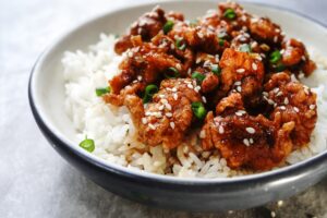 Golden Corral Copycat Bourbon Street Chicken over rice. Topped with Sesame Seeds and Snipped Green Onions