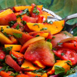 Bowl of fresh peach, tomato and basil salad