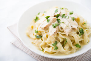 Easy Healthy Quick Dinner - Chicken Fettuccine Alfredo on white dinner plate