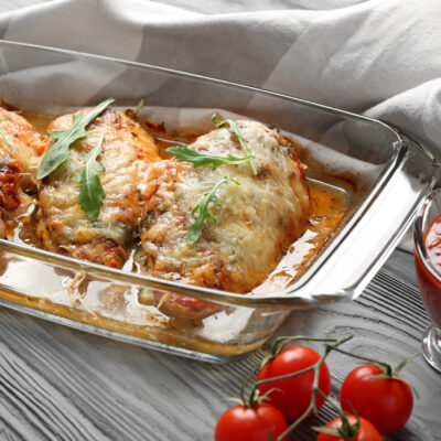 Delicious chicken parmesan meal with cheese and sauce in baking dish