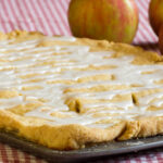 A pan of fresh apple slab pie with apples