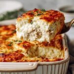 Baked turkey cottage cheese protein soufflé square lifted from casserole dish showing fluffy interior