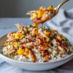 Rotisserie chicken spicy mango cottage cheese bowl with shredded chicken, mango chunks, rice and spicy sauce
