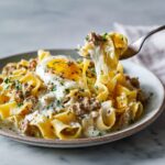 Turkey and cottage cheese protein egg ribbons with melted cheese and a soft egg on top.