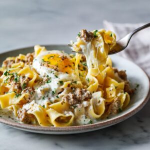 Turkey and cottage cheese protein egg ribbons with melted cheese and a soft egg on top.